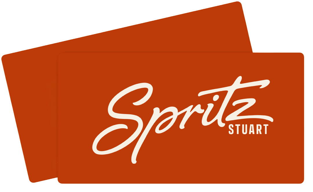 Two overlapping orange gift cards with the word 'Spritz' in large script and 'STUART' in smaller print.